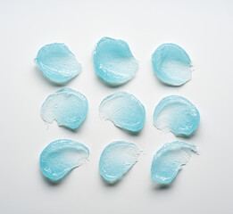 Brushes of light blue gel on a light background.