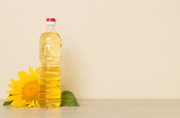 Sunflower oil and flower on wooden table