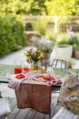 Breakfast on beautifully decorated table with flowers in garden