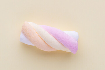 Colorful marshmallows on pastel background.