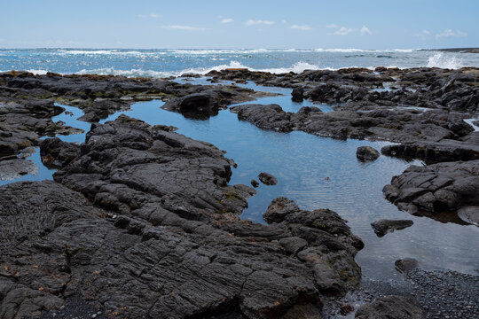 rocky punalu'u shore and ocean on horizon along kau coast of southeastern hawaii