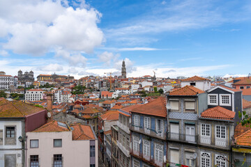 Fototapeta na wymiar Panoramic view of Porto, seen from the cathedral, with the bell towers of the churches and the colored houses on a sunny day with clouds.