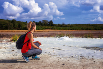 Hiker visits the caldera, a small circular crater with a marsh of sulphurous waters, evidence of the ancient presence of a volcano.