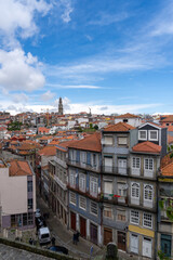 Fototapeta na wymiar Panoramic view of Porto, seen from the cathedral, with the bell towers of the churches and the colored houses on a sunny day with clouds.