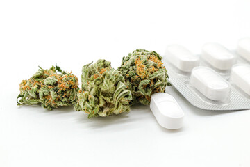 white pills and marijuana or joint weed isolated on white background 