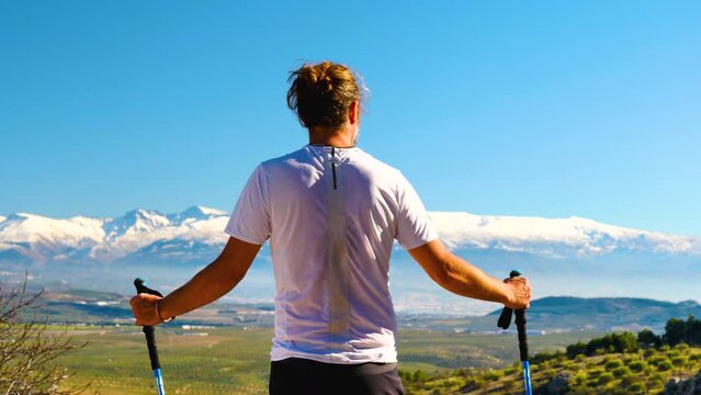 Hiker man enjoying panorama view of Sierra Nevada, Spain mountain
