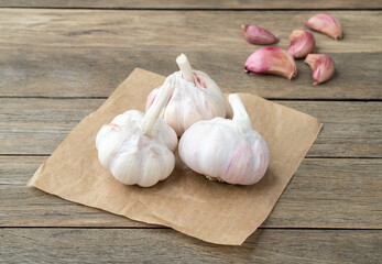 Garlic bulb and cloves over wooden table