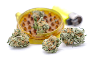 marijuana bud grinder and dried weed isolated on a white background