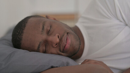 Fototapeta na wymiar African Man Sleeping in Bed Peacefully