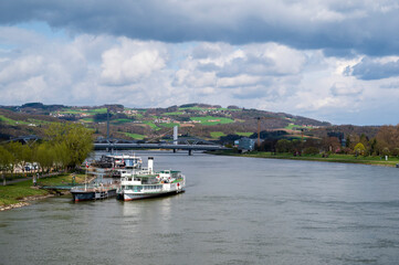 Fototapeta premium River Danube, boats and bridges between green meadows and forests near the city of Linz.