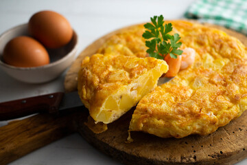 Garlic prawn omelette. Spanish traditional tapas. Recipe with potatoes, egg and prawns.