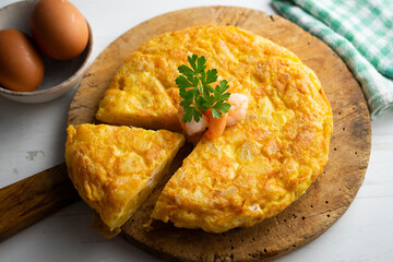 Garlic prawn omelette. Spanish traditional tapas. Recipe with potatoes, egg and prawns.