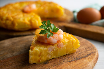 Garlic prawn omelette. Spanish traditional tapas. Recipe with potatoes, egg and prawns.