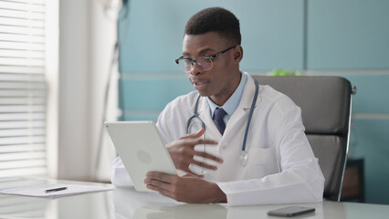 Young African Doctor making Video Call on Tablet in Office