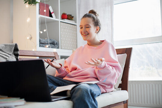 Teenager girl in an online lesson in high school