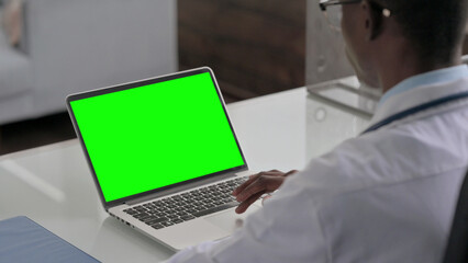 Young African Doctor Using Laptop with Green Screen
