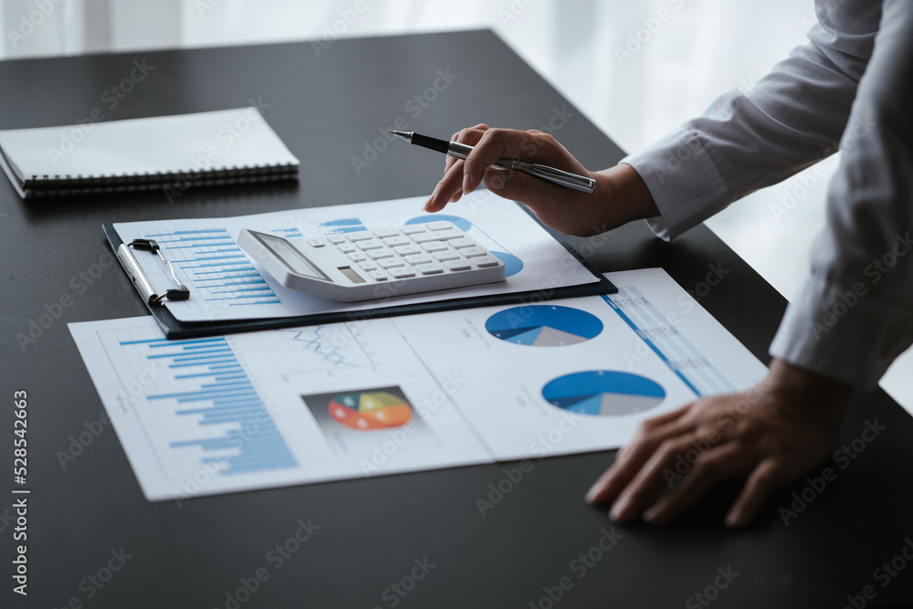 Poster close up of business hands working and calculating on financial and accounting graft and chart in of