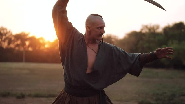 Ukrainian Cossack. Cossack with a saber in his hands is preparing for battle. Independent Ukrainian people. Patriots of their country.