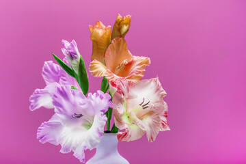 beautiful bouquet of summer flowers on a bright background in a vase