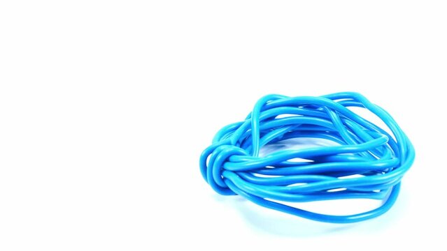 Blue wire cable of usb and adapter isolated on white background.Electronic Connector.Slow motion footage moving from right to left.Macro vdo.Selection focus.