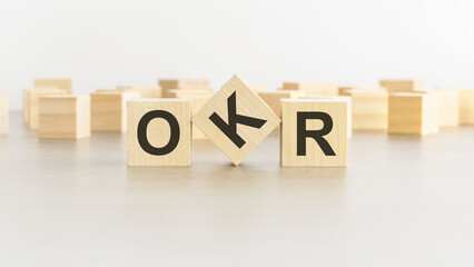 word OKR is made of wooden blocks on white background