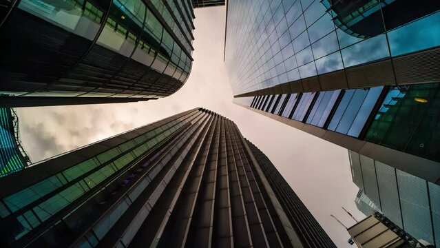 Low angle view skyscraper office building reflecting clouds timelapse hyperlapse