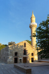 Fototapeta na wymiar Old mosque with a minaret on territory of Bodrum Castle or Bodrum fortress or Castle of St. Peter or Petronium, Turkey