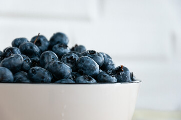 Blueberries close-up in a white cup. Blueberries close up. Selective Focus.