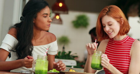 Candid casual pretty multi-ethnic girls at restaurant
