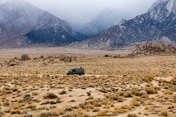 off road sprinter van in front of a snow covered mountain range in the sierra nevadas - obrazy, fototapety, plakaty