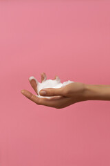 Female hands washing with soap on pink background