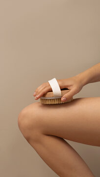 Womam using dry body brush to reduce cellulite, beauty concept. space for text