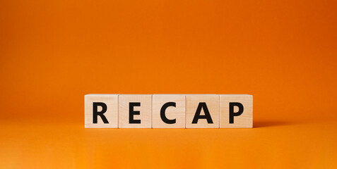 Recap symbol. Wooden cubes with word Recap. Beautiful orange background. Recap concept. Copy space.