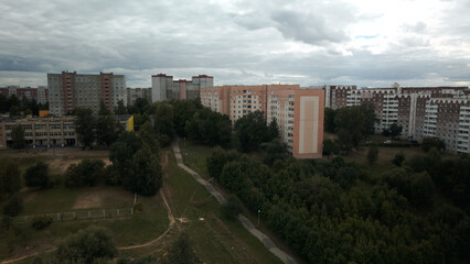 City with high-rise buildings. Park area in the foreground. Blue sky with clouds. Aerial photography.