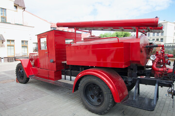 Elements of a vintage fire truck. The car is painted red. Close-up.