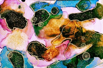 Golden dust and rings on blue and rust Alcohol ink fluid abstract texture fluid art with gold glitter and liquid.