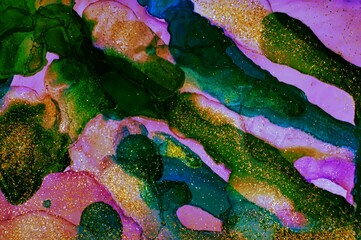 Golden dust on deep green and pink Alcohol ink fluid abstract texture fluid art with gold glitter and liquid.