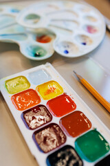 palette of watercolor paints for children and adults for drawing on paper. art school additional creative education for schoolchildren and parents. art therapy for the treatment of anxiety disorders