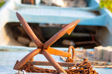 An anchor on the boat and view of the lake