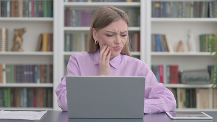 Fototapeta na wymiar Woman having Toothache while Working on Laptop