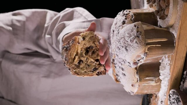 Easter dove in female hands . Colomba di Pasqua - traditional italian easter dove cake with glaze macaranage, almonds. Easter dove on a board. High quality 4k footage