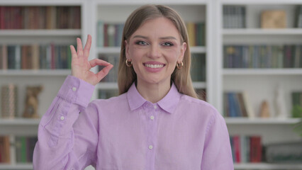 Portrait of Woman showing OK Sign at Home