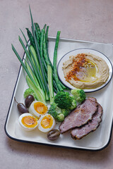 Breakfast with backed meat, hummus and green vegetables, copy space - 528565032