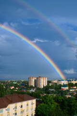 Beautiful bright double rainbow over the small city