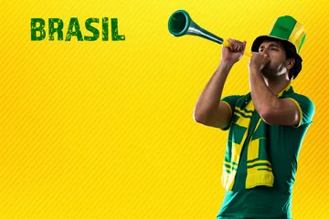 Fotobehang brazilian player, man celebrating on a yellow background © beto_chagas