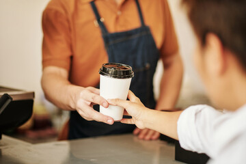 Obraz na płótnie Canvas Barista Giving Coffee Cup to Customer