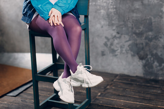 Young sporty woman 80 and 90's style. 90s fashion legs tights close up girl