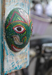 mask on display; antique mask; traditional mask, brow, cultural mask, old mask; image with a bokeh Traditional mask carved on wood on display in Galle Dutch Fort Sri Lanka