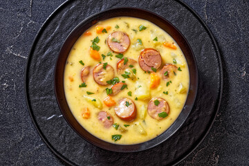 German potato soup with sausages in bowl