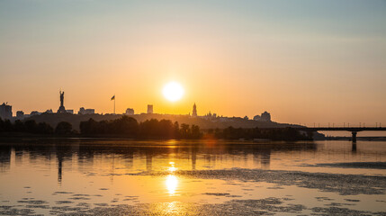 Obraz na płótnie Canvas View of Kyiv from left bank of Dnipro river at sunset
